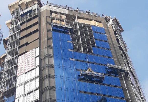 suspended access cradles being used on a tall building in saudi arabia